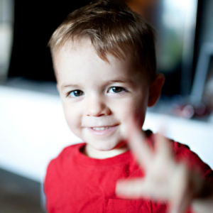 Young boy waving